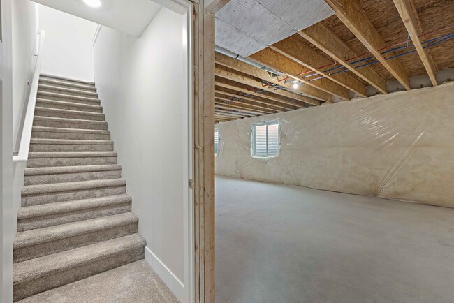 Building Photo - NEW HOME with large garage stalls and unfinished basement for additional storage