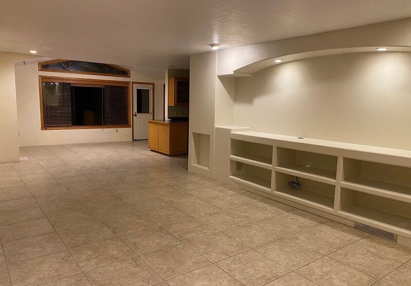 Living room with built-in entertainment area. Recessed lighting sets the mood for the space. - 491 E Juniper Dr