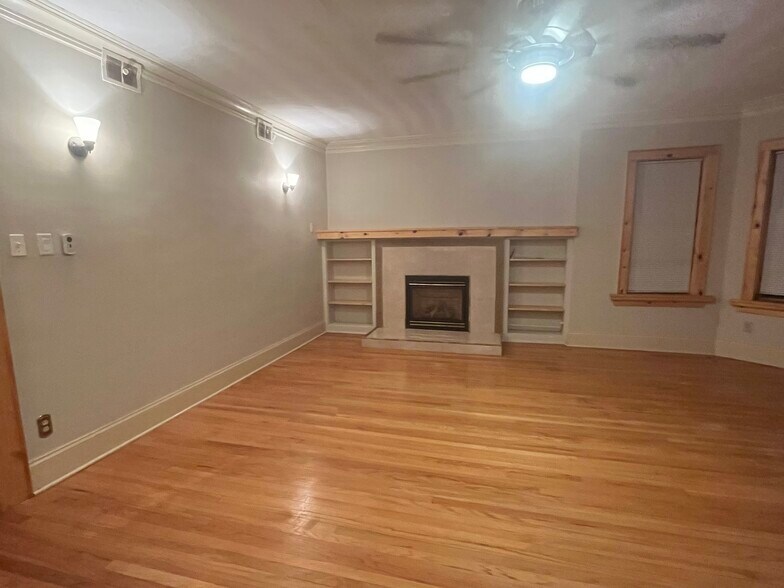 mantle and shelving surrounds fireplace - 7619 S Phillips Ave