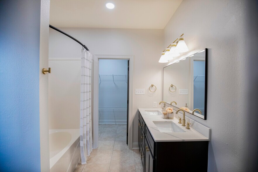 Primary Bathroom features brand new double vanity, large soaker tub and massive walk in closet - 11284 Shelly St