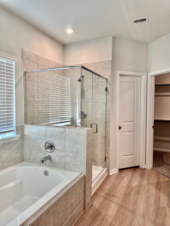 The primary bathroom has a separate shower and soaker tub! - 507 Turtle Dove Dr
