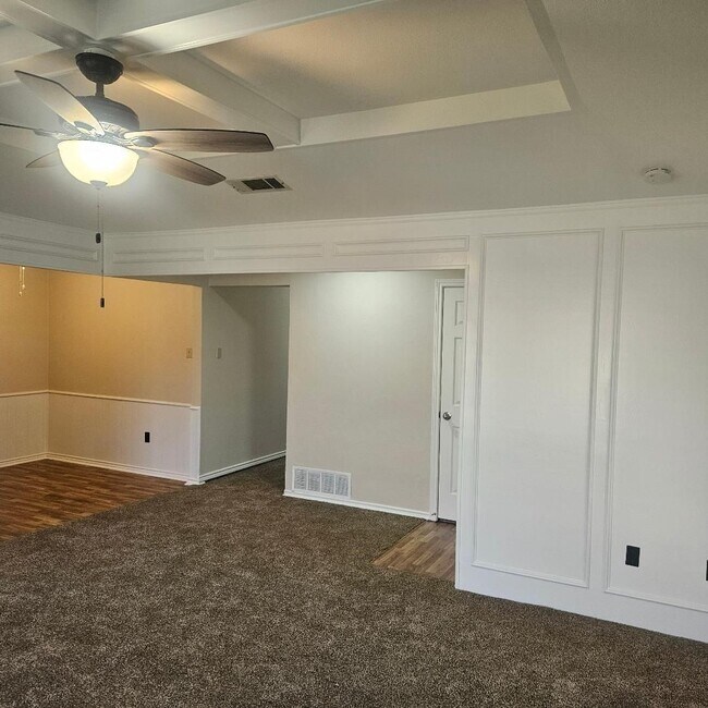 Building Photo - Three bedroom and two bathroom nicely remodeled with new flooring. Large wood fenced backyard