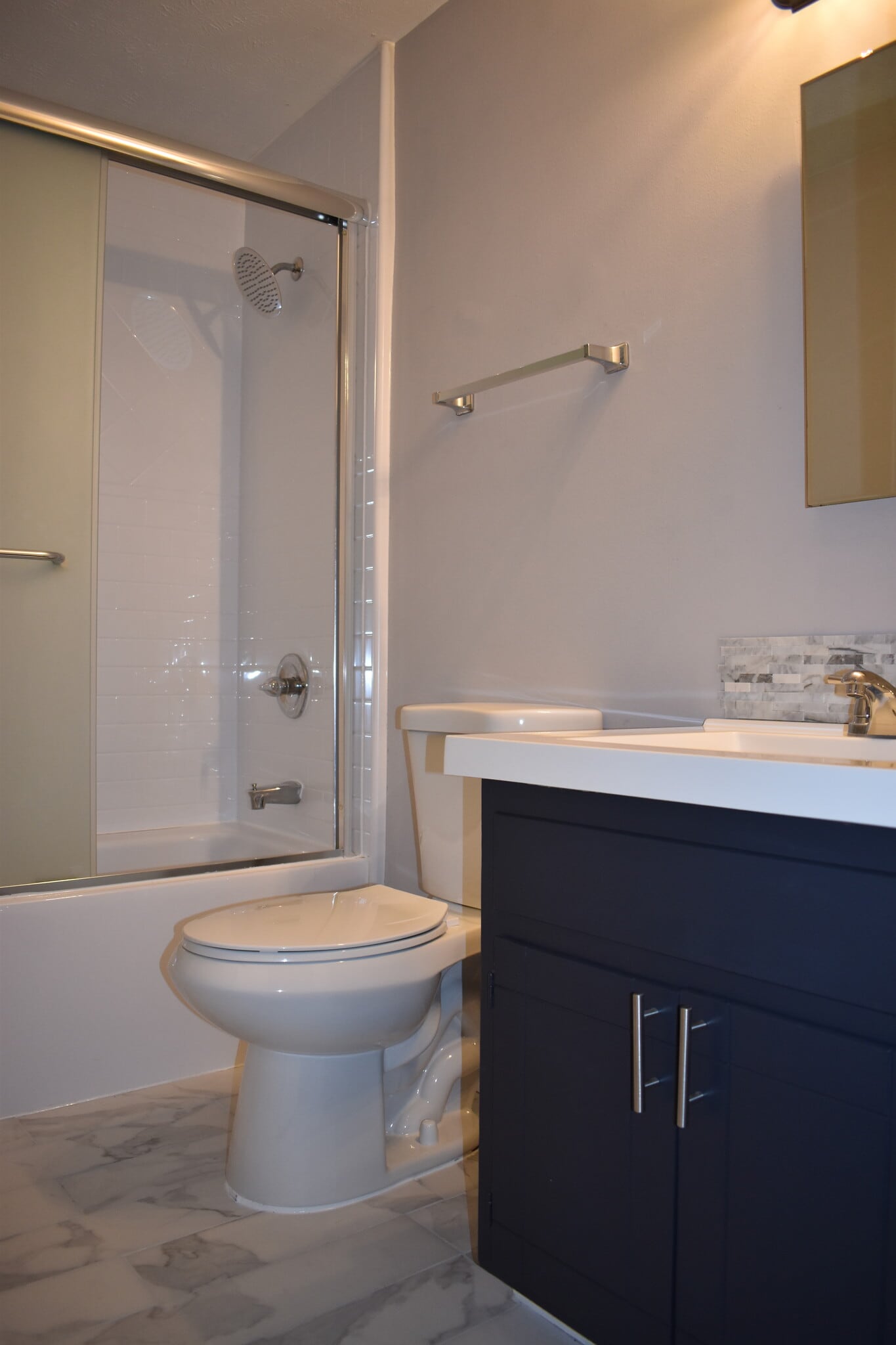 Updated bathroom with new tile, shower head, toilet and vanity top. - 610 River Rouge Dr
