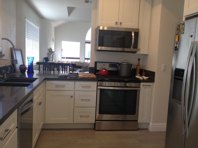 newly remodeled kitchen with quartz countertop and white cabinet and stainless steel appliances - 14572 Dickens St
