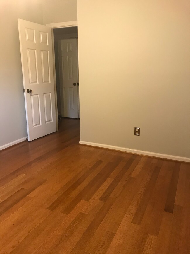 Second bedroom with fresh paint and hardwood floors. - 107 Swanton Hill Ct