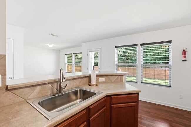 Building Photo - Spacious 4BR Home with New Carpet & Fenced Backyard