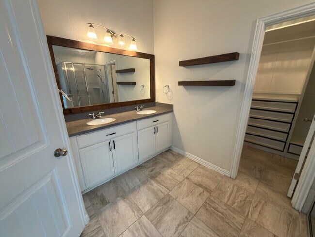 Building Photo - Four bed two bath on a corner lot with a pool in Sunfield. Gas cook top, double ovens. Open kitch...