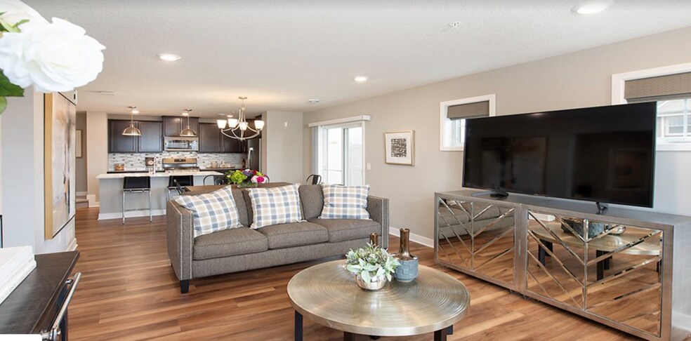 Main level provides open concept living room, dining, eat in kitchen, powder room, storage and mechanicals. Corner unit means you have extra south facing windows, your own patio and lots of natural sunlight. Beautiful hard woods throughout this level. (model home picture) - 4825 Martingale Drive