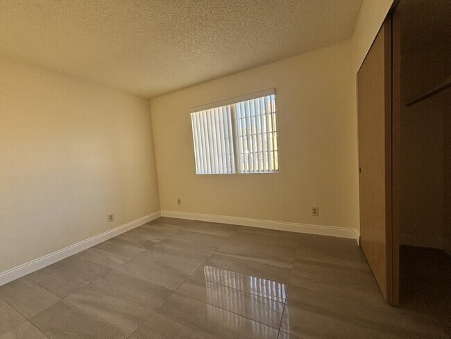 Building Photo - Downstairs 2BR/1BA—recently updated with new flooring, new countertops, and clean, neutral finishes.