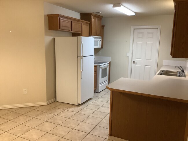 Kitchen with provided refrigerator - 431 Firewood Dr