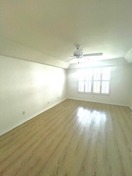 main bedroom with lake view and hurricane impact windows - 6660 Ilex Cir