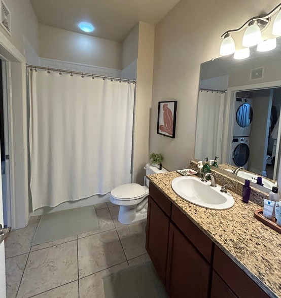 Bathroom 1 is off the kitchen and connects to the walk in closet of one of the bedrooms - 1700 N Emerson St