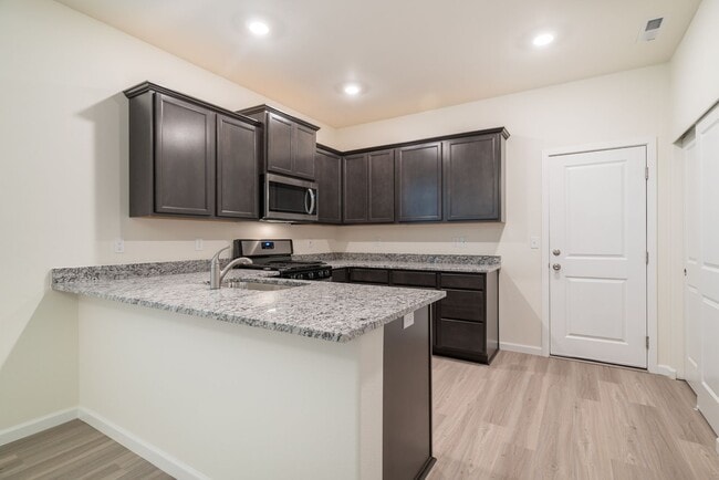 Building Photo - Super clean & spacious 4-bdrm/3-bath townhome in NE—Attached garage, great location