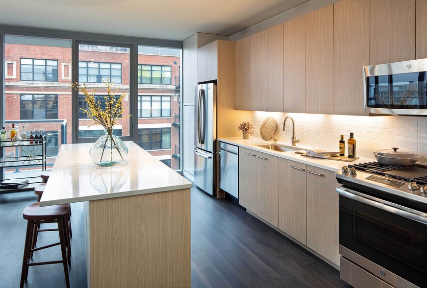 Elegant island kitchen with stainless-steel appliances - AMLI West Loop