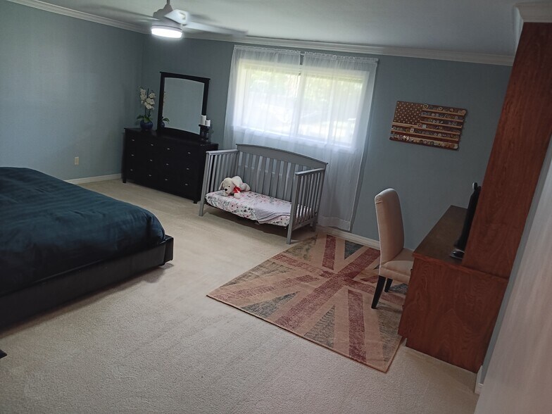 Primary bedroom has window looking out into backyard - 2308 Wesley Cir
