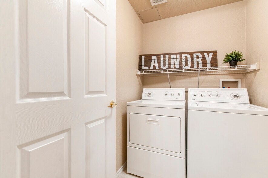 The laundry room is equipped with a washer and dryer, located just off the family room for ease and convenience - 3960 Riviera Grove