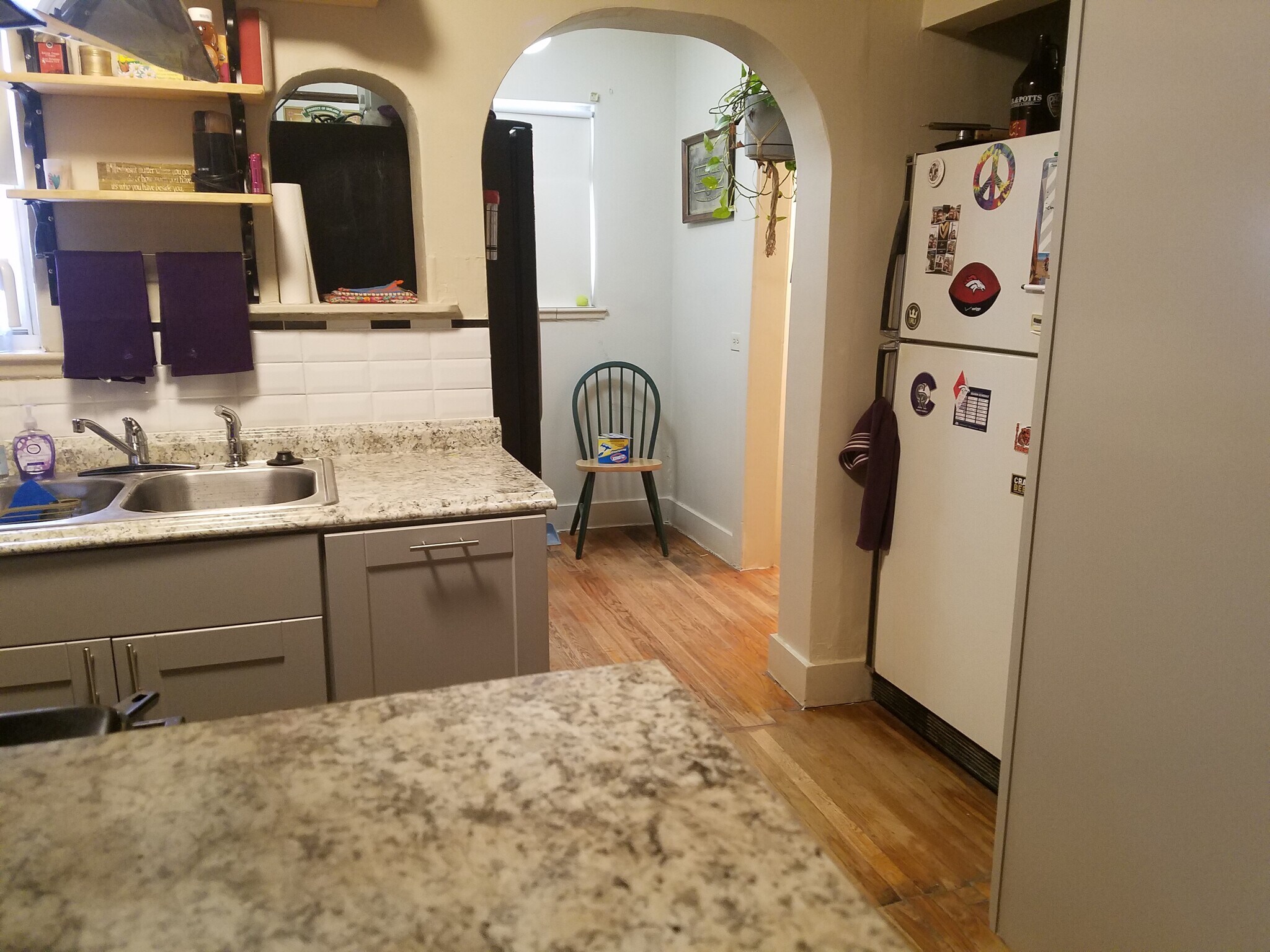 Kitchen with two fridges and stairs to back door and downstairs. - 521 Harrison St