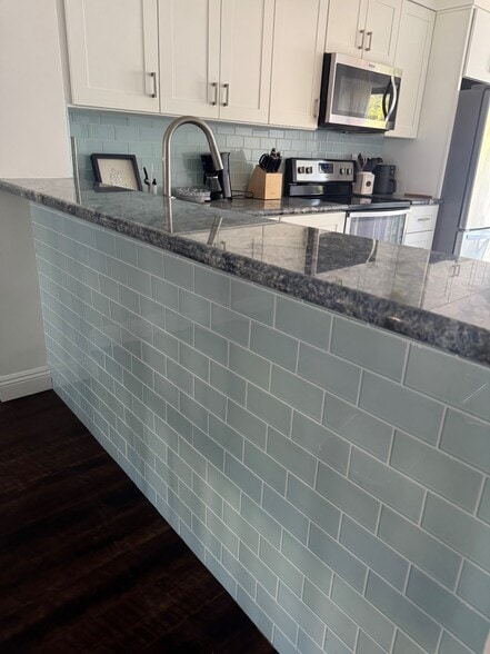 Contemporary kitchen with blue subway-tile, bar front, and blue granite countertops - 3412 Via Alicante