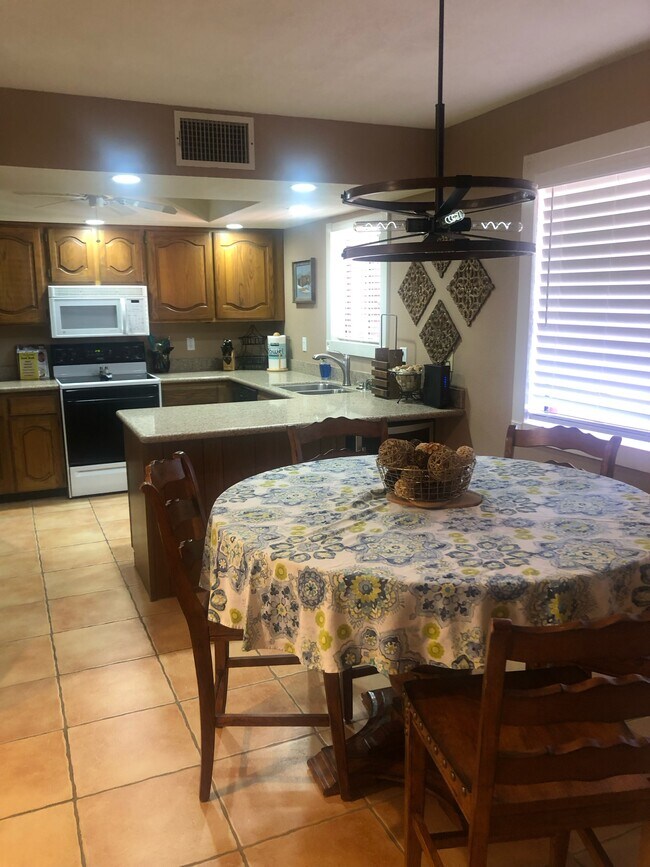 Seating for 4 and view of large screen television - 4303 E Cactus Rd