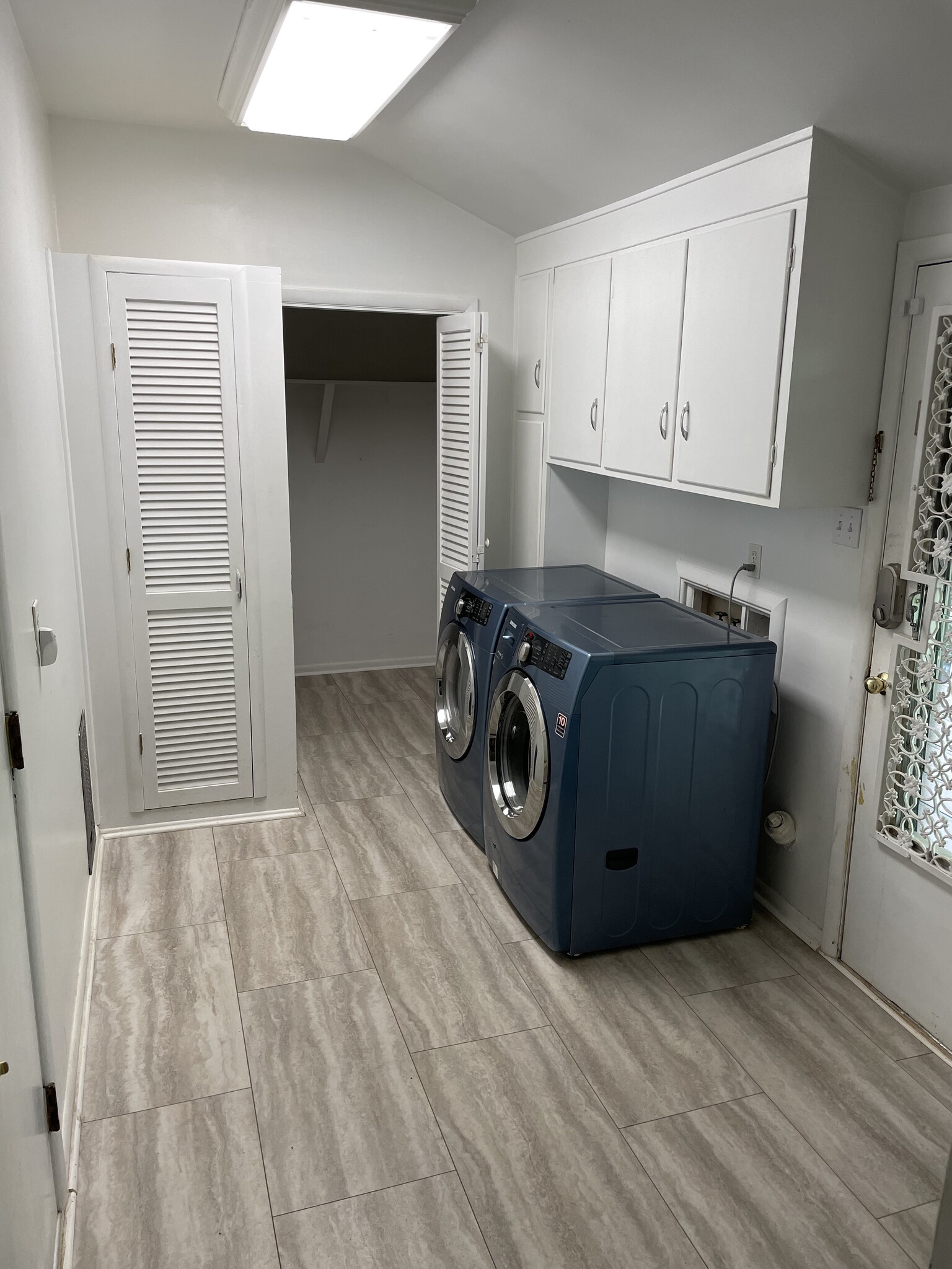Washer dryer with plenty of closet space leading to garage (L) and backyard (R) - 8205 Ainsworth Dr