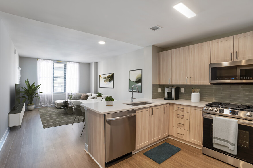 Renovated Package II kitchen and living room with hard surface flooring - Avalon at Gallery Place