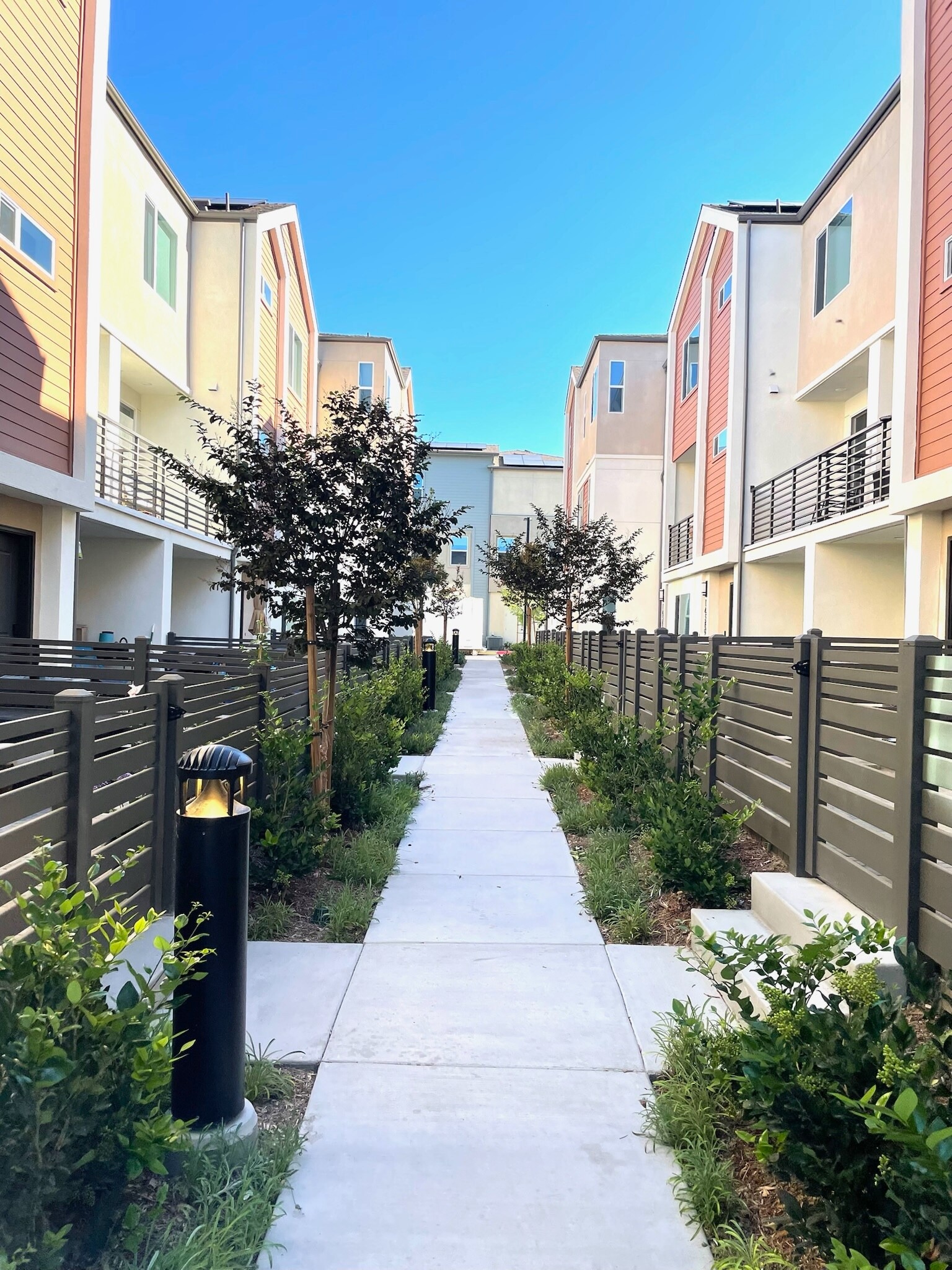 Entrance to townhouse, lined with trees. - 14350 Savannah Ct