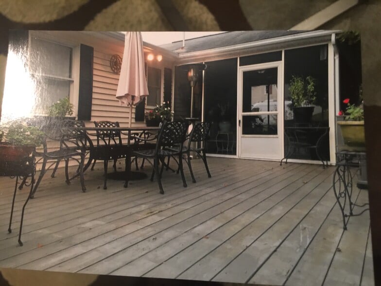 View from shared deck to sunroom. You enter from backyard. - 7288 Beechtree Ct