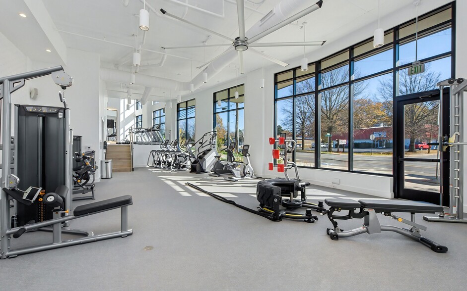 Gym with Cable Weights, Treadmills, and Expansive Street-Facing Windows - NoDa Flats