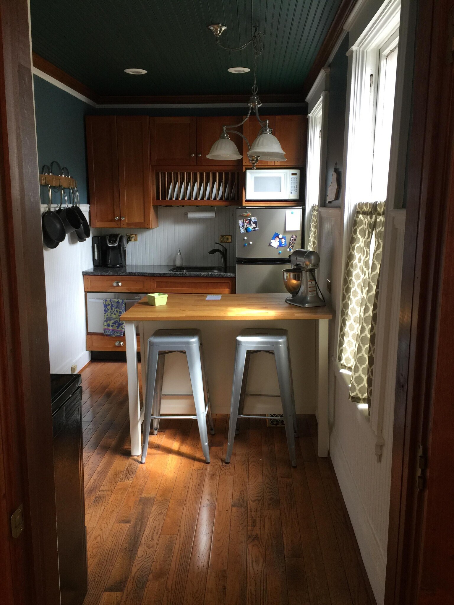 View of kitchen from living room, dining room, table and stools included - 130 Park Pl