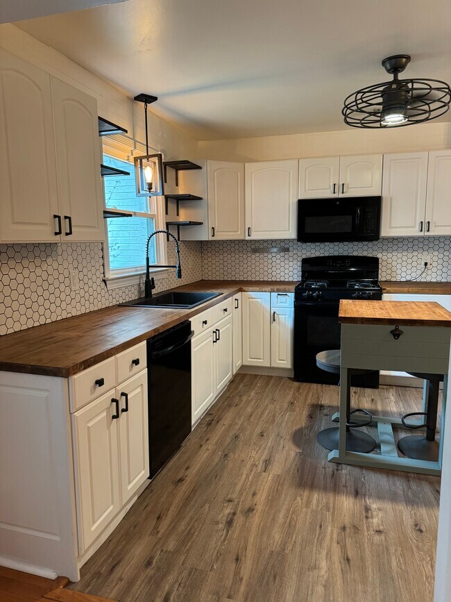 Butcher block counters and white cabinets for a modern farmhouse feel - 6111 Northlakes Dr