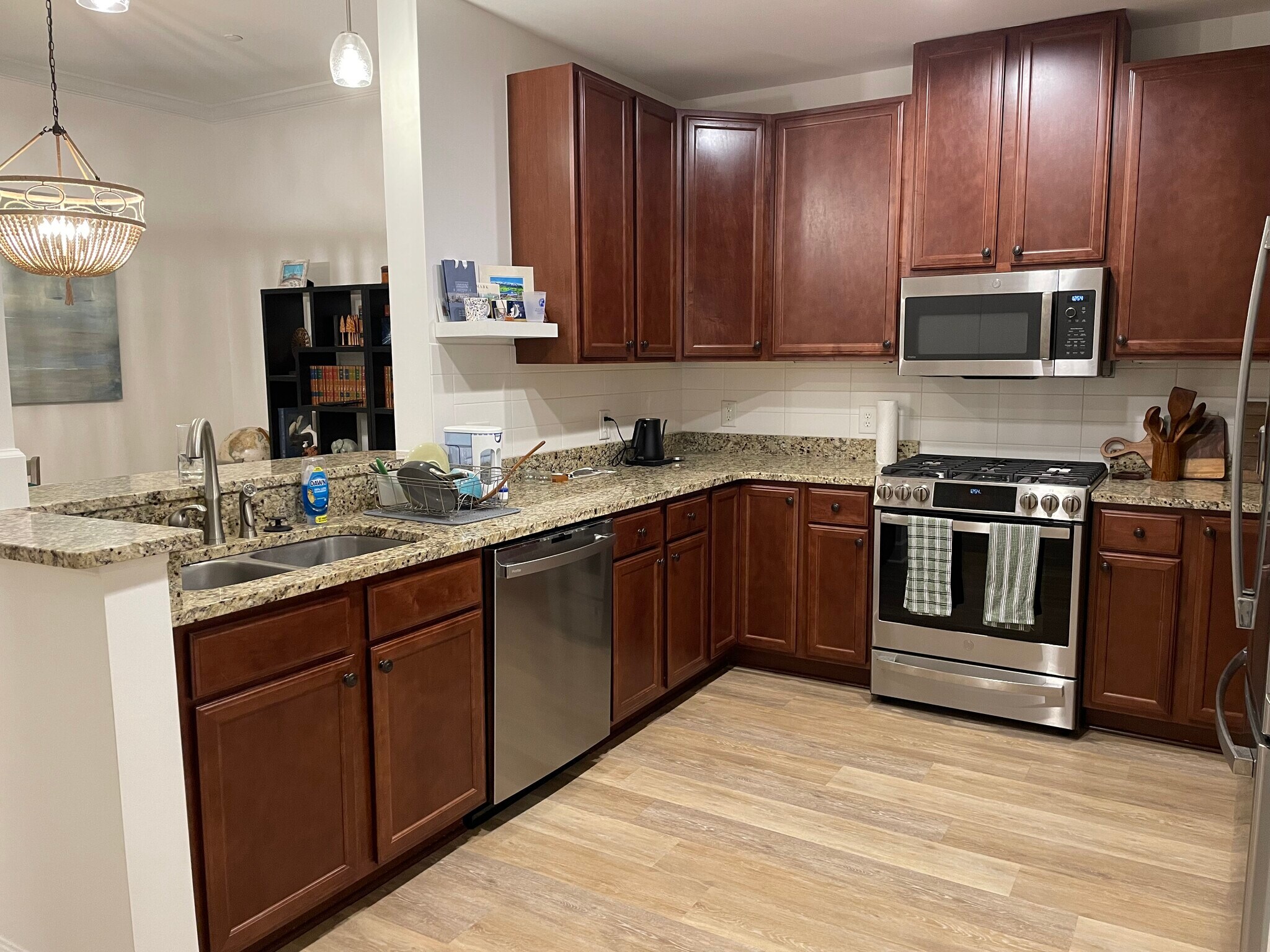 The kitchen featuring expansive granite countertops, state-of-the-art appliances, and ample storage - 145 Pier View St