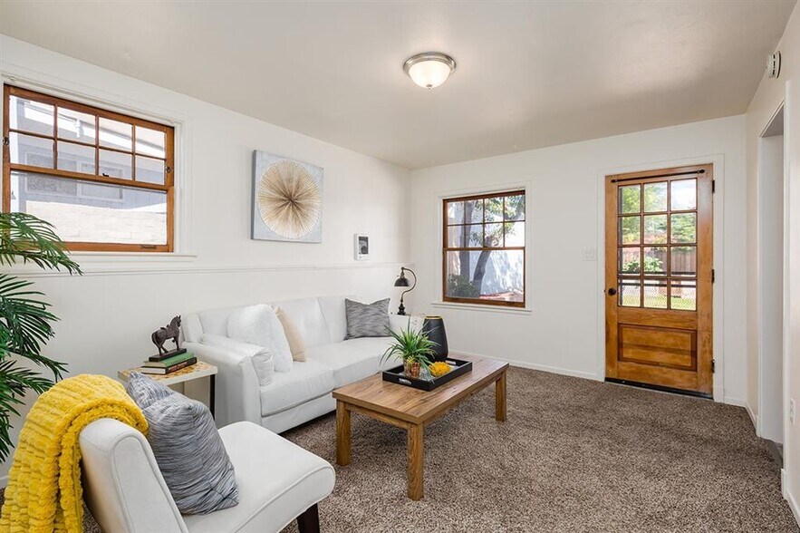 Living area with a view to the front door and patio/backyard. - 1931 33rd St