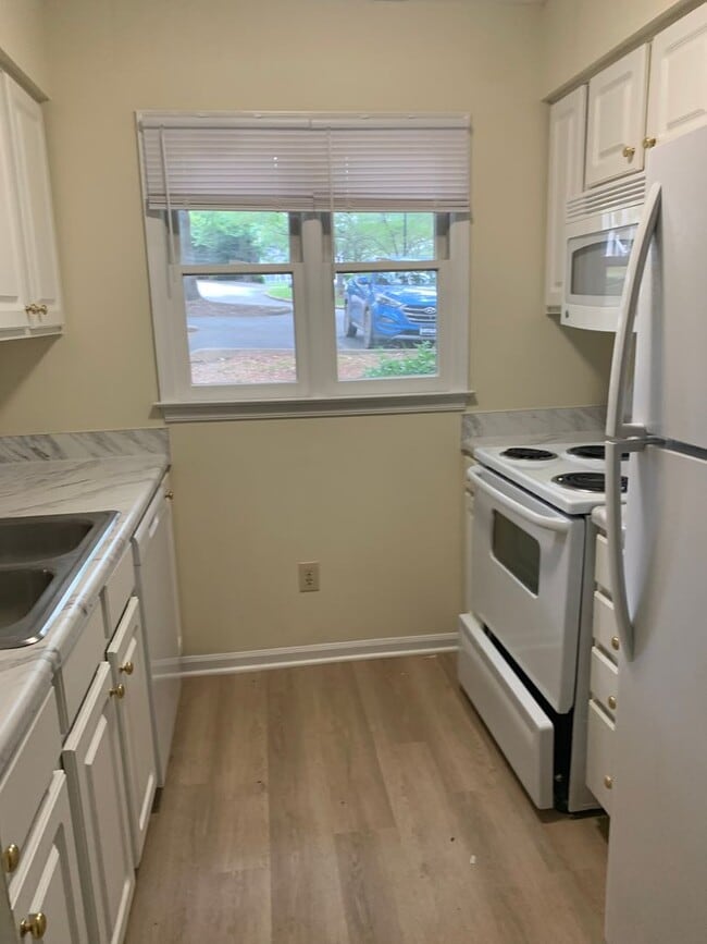 Building Photo - ONE LEVEL CONDO NEAR REX HOSPITAL -Firepla...