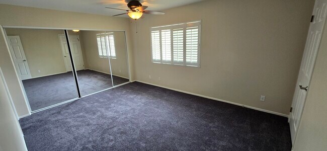 Master bedroom with wall-to-wall mirrored closet. Carpet color is Steeel Gray - 14365 Foothill Blvd