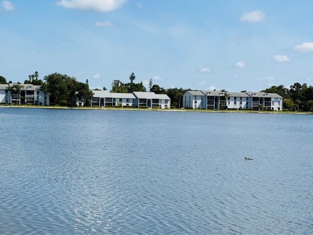 charming walkway offers a picturesque view of the serene pond, perfect for a peaceful stroll. - 9570 Green Cypress Ln