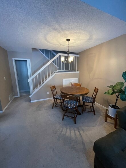 Dining room with pull out storage unit under the stairs. - 15805 24th Ave N.