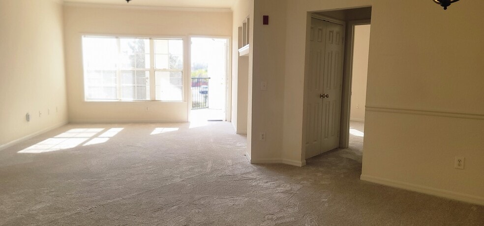 Living room with access to the patio and build in entertainment center - 3707 Conroy Rd