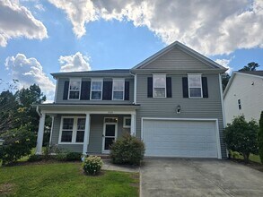Building Photo - Spacious 4BR, 2.5BA Home with Screened Pat...