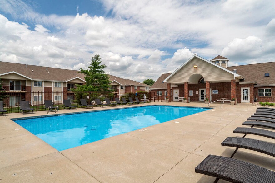 Our community features a sparkling pool and plenty of lounge seating, offering the perfect place to relax and enjoy sunny days. - Northbrook Apartments