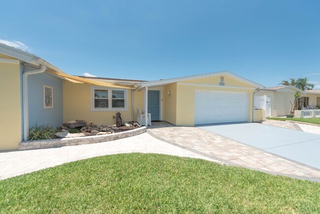 Building Photo - Live the ultimate Space Coast waterfront lifestyle at this stunning beachside canal home in Satel...