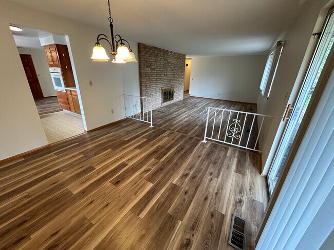 Dining Room with step down Family Room and fireplace - 8519 49th St W