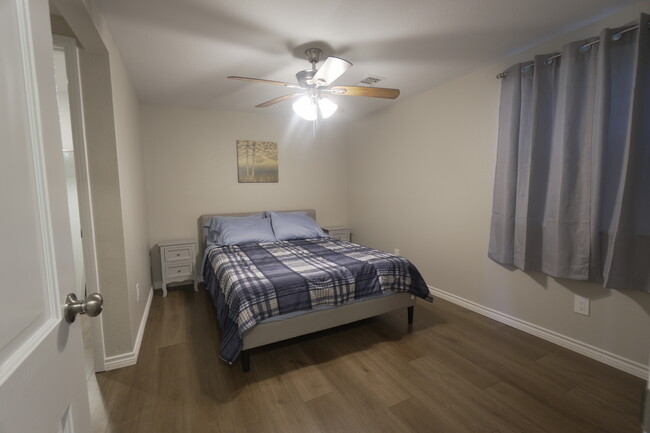 Bedroom 1 features a queen bed and a walk in closet - 2708 Pin Oak Ln