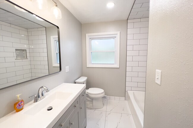 First floor bath with ceramic tile floor and subway tiled bath - 811 S 88th St