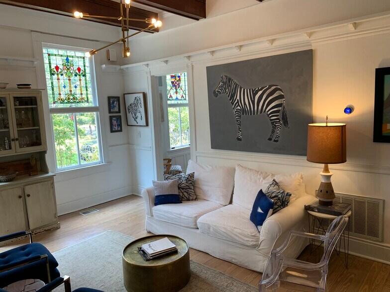 Living/room den with stained glass windows. - 1316 Pleasant St