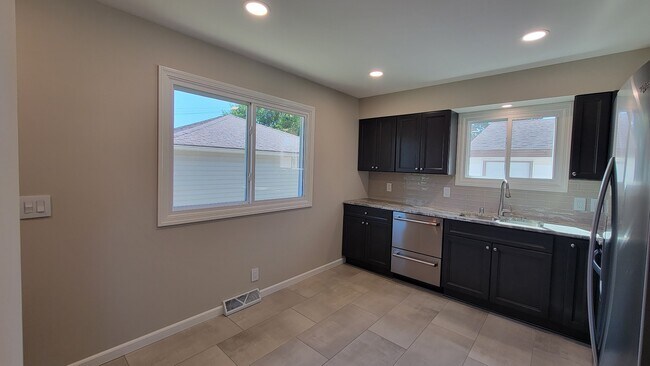New Kitchen Cabinets and quartzite countertops. New stainless appliances. New Tile and backsplash. - 6305 49th Ave