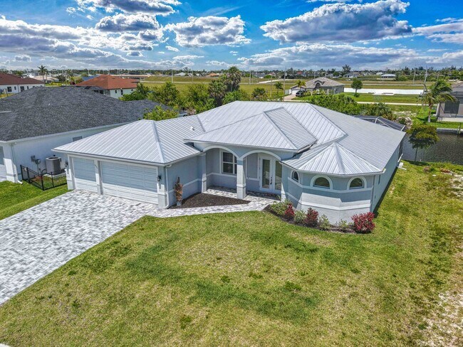 Building Photo - NOW AVAILABLE - Gorgeous Pool Home ~ NW Cape ~ 3 Car Garage ~ On Canal!