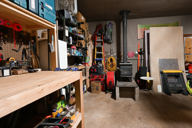 Garage. Perfect space for fabrication shop, storage, or to park your car. Has woodstove - 2507 3rd St NE