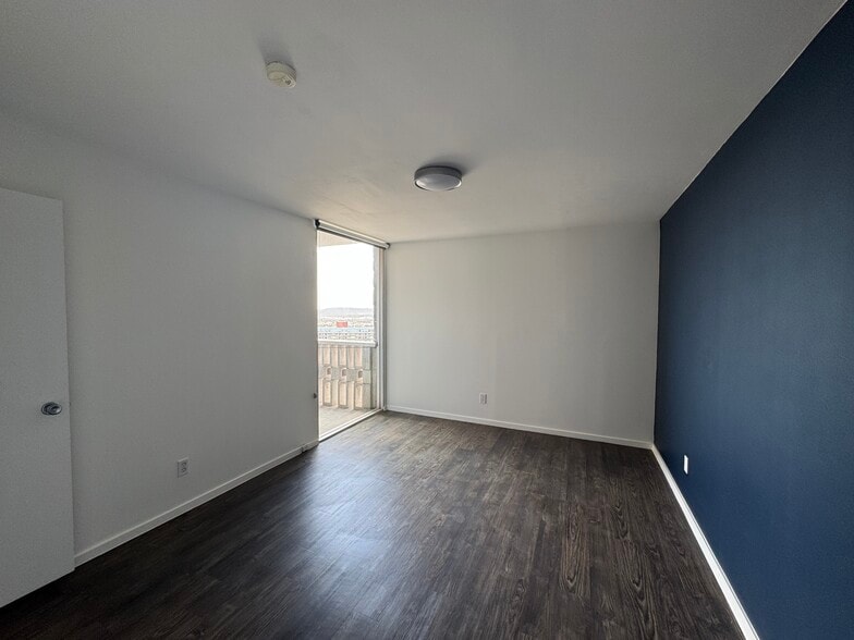 Bedroom features large window with blackout shade - 1502 S Boulder Ave
