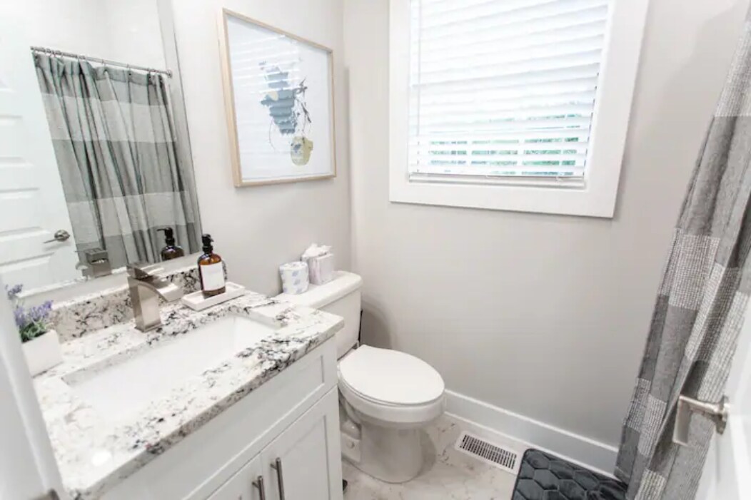 Second-Floor Bathroom: stylish bathroom featuring a granite countertop and a combo tub/shower. - 421 Elysian Fields Rd