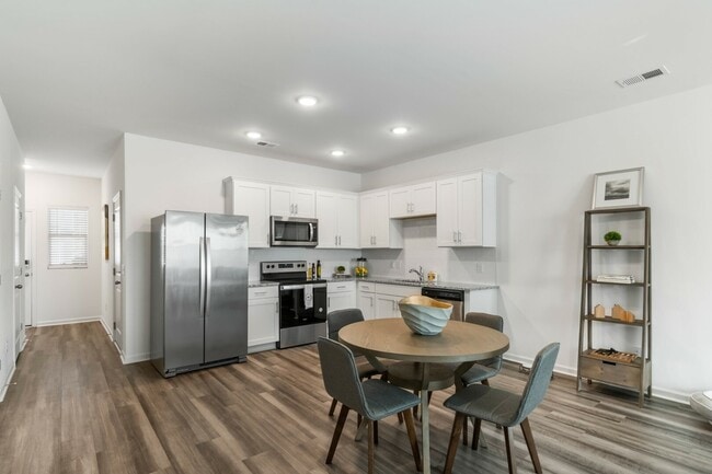 Open Kitchen with Stainless Steel Appliances and White Cabinetry - Covey Homes Clements Ferry